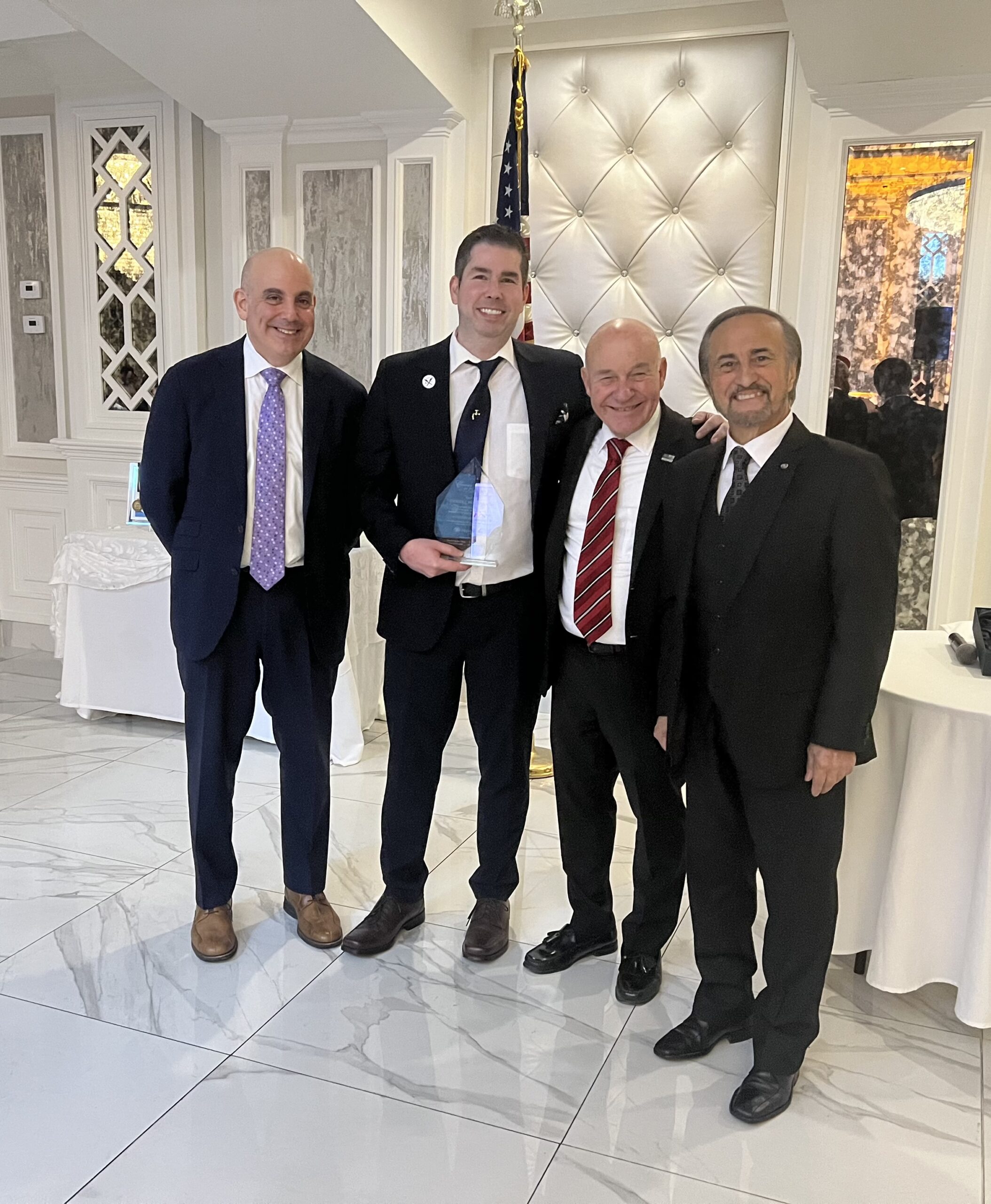 Stephen Ferdinando with his award; and from left: Dr. John Marshall, chair of the Department of Emergency Medicine and vice president for medical affairs at Maimonides; Brian Long; and Frank Naccarato, co-chair of Community for Kids and board member/trustee of Maimonides Medical Center at eighth annual Community for Kids Benefit.