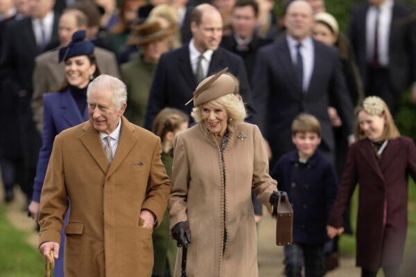 <b>NORFOLK — Casual brown earth tones keep the King and Queen warm approaching Christmas services:</b> Britain's King Charles III and Queen Camilla arrive to attend the Christmas day service at St Mary Magdalene Church in Sandringham in Norfolk, England, Monday, Dec. 25, 2023.<br>Photo: Kin Cheung/AP