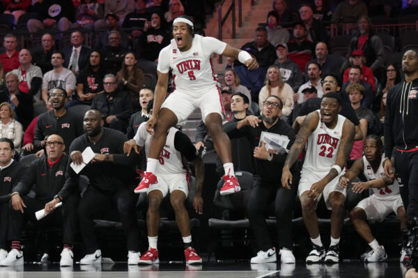 <b>NEVADA — ‘This bench cannot hold me down…’:</b> UNLV forward Rob Whaley Jr. (5) celebrates from the bench as UNLV scores against Creighton during the second half of an NCAA college basketball game Wednesday, Dec. 13, 2023, in Henderson, Nev.<br>Photo: John Locher/AP