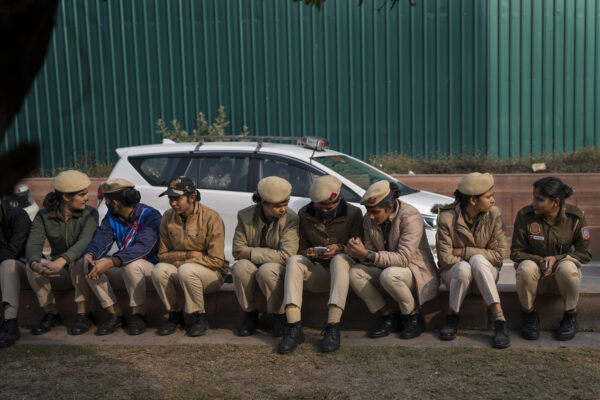 <b>NEW DELHI — ‘Yes, the hats are cool, but we have more important things on our minds’:</b> Delhi policewomen rest on a sidewalk ahead of a march by suspended lawmakers in New Delhi, India, Thursday, Dec. 21, 2023. Dozens of opposition lawmakers suspended from Parliament by Prime Minister Narendra Modi's government for obstructing proceedings in the chamber held a street protest on Thursday accusing the government of throttling democracy in the country.<br>Photo: Altaf Qadri/AP
