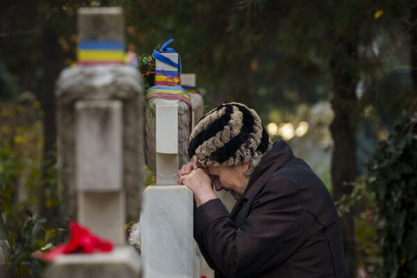 <b>BUCHAREST — More sad repercussions from political wars:</b> A woman cries leaning on a gravestone during a memorial religious service for those killed in the 1989 anti-communist uprising, in Bucharest, Romania, Thursday, Dec. 21, 2023. Romania marked the 34th anniversary of the anti-communist uprising which started in the western Romanian town of Timisoara on Dec. 16 and in Bucharest on Dec. 21, 1989, leaving more than one thousand people dead and ending the rule of dictator Nicolae Ceausescu.<br>Photo: Andreea Alexandru/AP