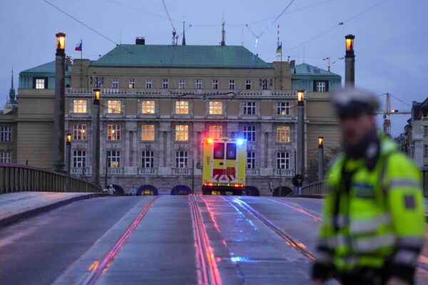 <b>PRAGUE — Presence of ambulance expresses the alarm of a recent mass shooting:</b> An ambulance drives towards the building of the Philosophical Faculty of Charles University in downtown Prague, Czech Republic, Thursday, Dec. 21, 2023. Czech police say a shooting in downtown Prague has killed an unspecified number of people and wounded others.<br>Photo: Petr David Josek/AP