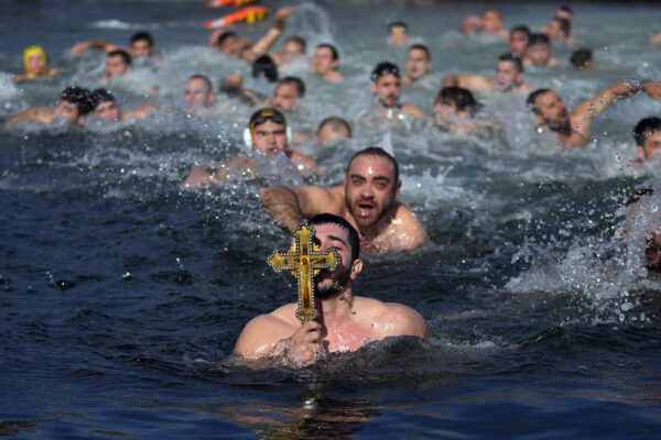 <b>ISTANBUL — Religious holiday brings some discomfort with the celebration:</b> Greek Orthodox faithful holds up a wooden crucifix after retrieving it in the Golden Horn during Epiphany day in Istanbul, Turkey, Saturday, Jan. 6, 2024. By tradition, a crucifix is cast into the waters of a lake or river, and it is believed that the person who retrieves it will be freed from evil spirits and will be healthy throughout the year.<br>Photo: Khalil Hamra/AP