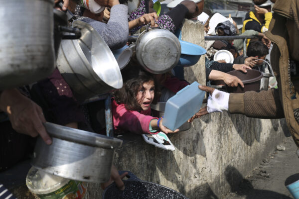 GAZA — Desperation for nourishment: Palestinians line up for free food during the ongoing Israeli air and ground offensive on the Gaza Strip in Rafah, Tuesday, Jan. 9, 2024.Photo: Hatem Ali/AP