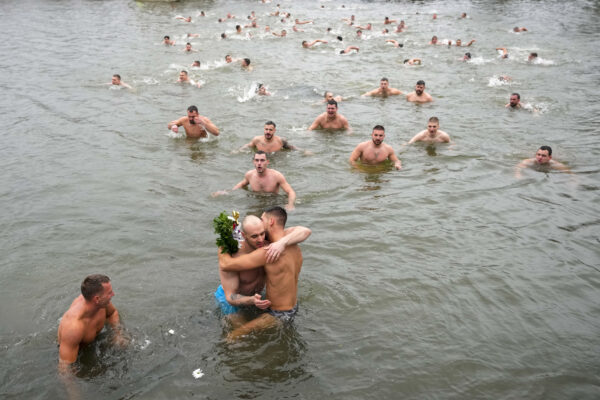 <b>BELGRADE — Tradition and faith rule when searching for something in frigid waters, scantily clad:</b> Swimmers find the cross after it was retrieved from the Becmen Lake, near the village of Becmen, near Belgrade, Serbia, Friday, Jan. 19, 2024. Orthodox Serbs celebrate Epiphany on January 19, following the old Julian calendar, with the traditional retrieving of crosses from the rivers and lakes.<br>Photo: Darko Vojinovic/AP