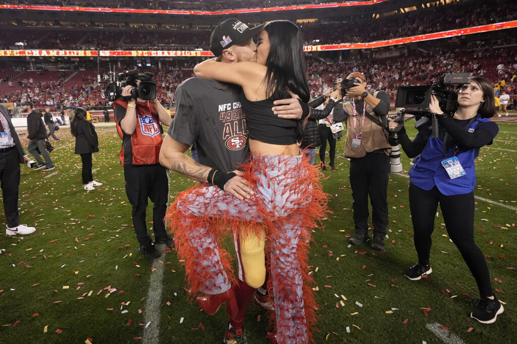SANTA CLARA — ‘We’re going to the Superbowl in Vegas — but they might not let me wear these pants’: San Francisco 49ers tight end George Kittle, middle left, celebrates with his wife, Claire, after the NFC Championship NFL football game against the Detroit Lions in Santa Clara, CA, Sunday, Jan. 28, 2024. Kittle and his wife will go up against tight end Travis Kelce and Taylor Swift in Vegas.Photo: Mark J. Terrill/AP