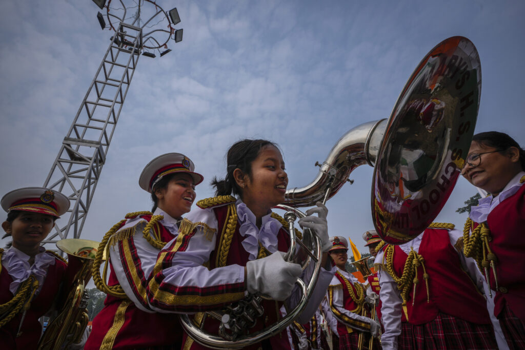 INDIA — Home of the most colorful festivals in the world: A school student helps another to hold a musical instrument before participating in the Republic Day parade in Guwahati, India, Friday, Jan. 26, 2024.Photo: Anupam Nath/AP