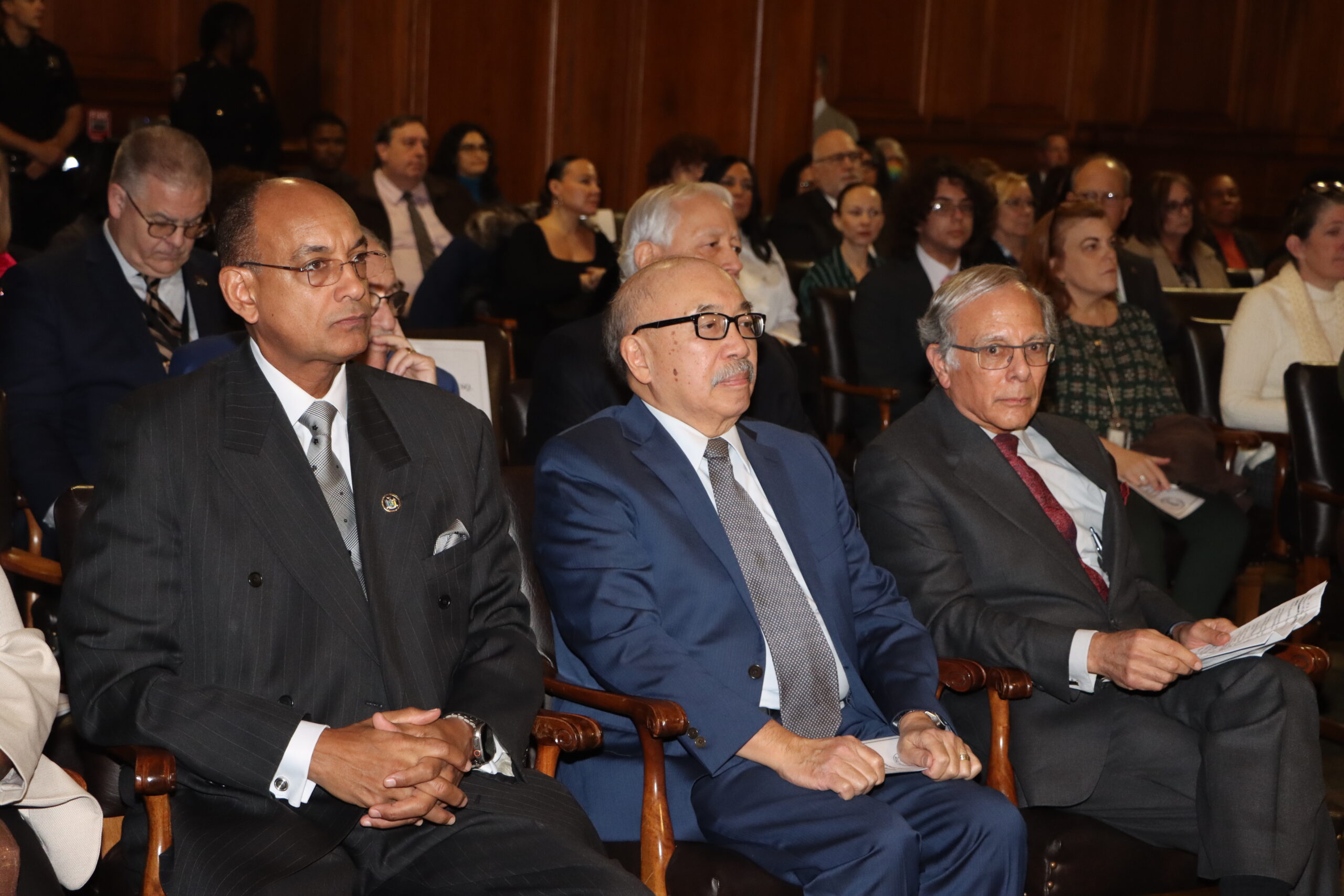 With a front row seat, from left to right, Hon. Norman St. George, former Presiding Justice Randall Eng and Scott Mollen at Milton Mollen Commitment.