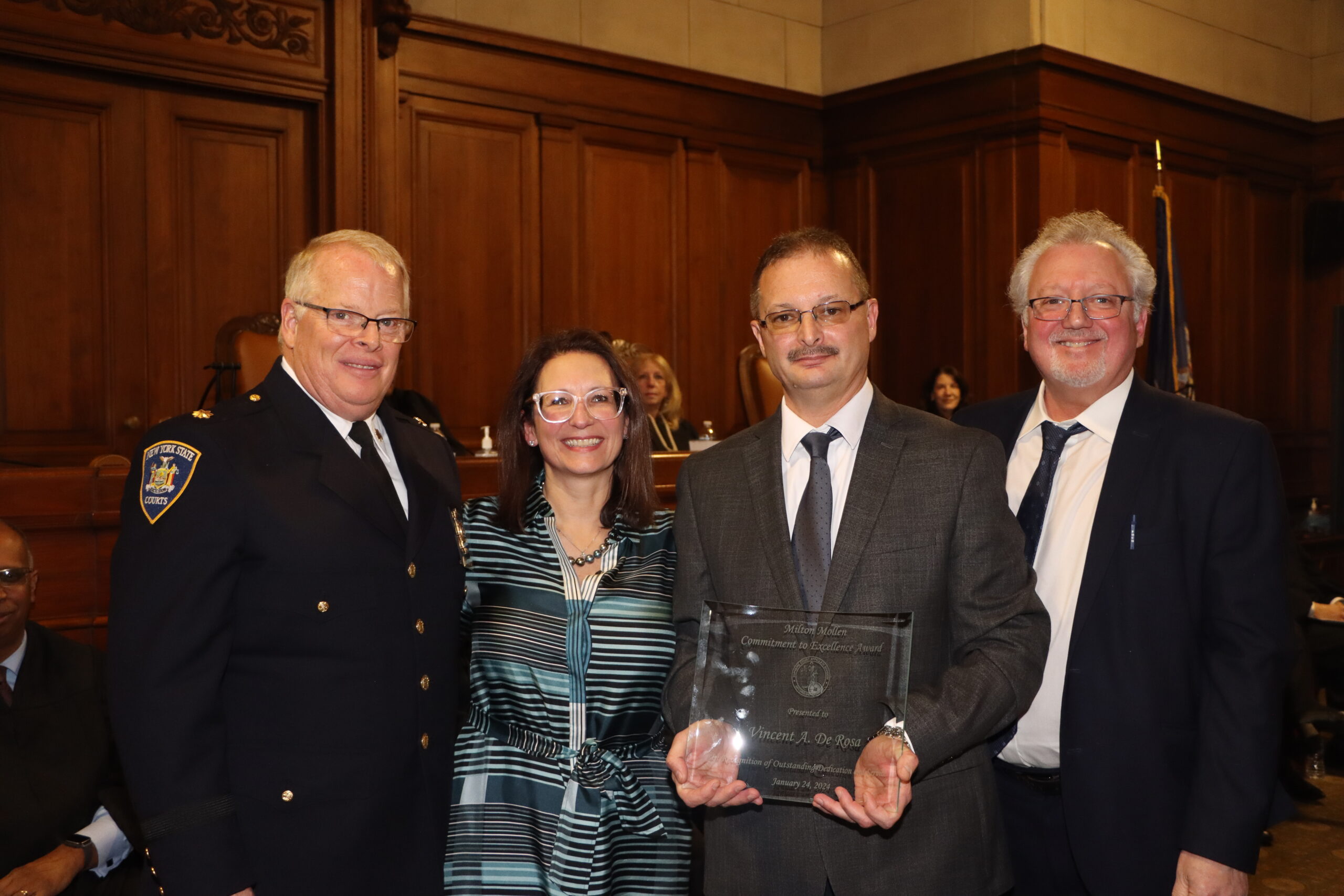 Vincent DeRosa (second from right), court clerk specialist from the Queens Supreme Court, Criminal Term was presented with the Mollen Award at Milton Mollen Commitment.