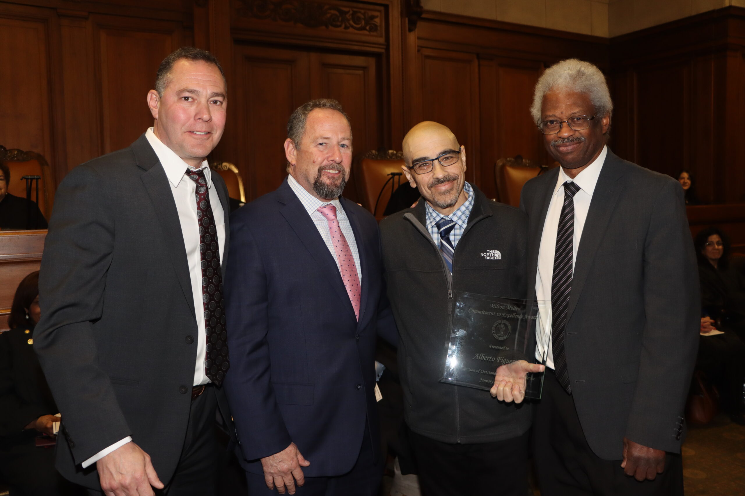 Alberto Figueroa (second from right), senior court clerk from the Staten Island Supreme Court, Criminal Term, received the 2024 Mollen Award from Hon. Desmond Green (right) and Kenneth Fay (left) at Milton Mollen Commitment.