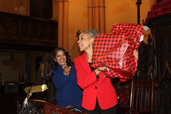 Maya Wiley proudly displays the symbolic chair, echoing the late Shirley Chisholm's empowering message at Linda Wilson's swearing-in.
