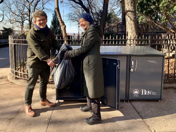 Koren Volk, president of the Brooklyn Heights Association, and Councilmember Lincoln Restler jointly chucked a bag of garbage into one of the new CITIBINs installed at the Promenade entrance at Montague Street on Jan. 5.