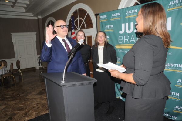 Councilmember Justin Brannan being sworn in by Attorney General Letitia James.