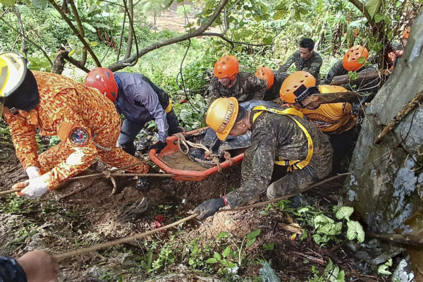 <b>PHILIPPINES — Nature’s revenge — more fatalities from heavy rains:</b> In this handout photo provided by the Municipality of Monkayo, rescuers retrieve the body of one of the victims after a landslide due to heavy rains at Monkayo town in Davao de Oro province, southern Philippines on Friday, Jan. 19, 2024. A landslide set off by days of heavy rain buried a house in the southern Philippines where people were holding Christian prayers, killing multiple people, including children, and seriously injuring some others, a disaster-response official said.<br>Photo: Municipality of Monkayo via AP