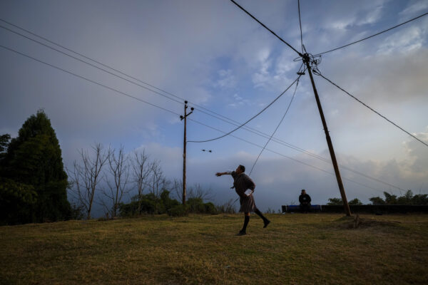 <b>BHUTAN — A more athletic, outdoor version of darts:</b> An election official plays Khuru, a traditional game outside a polling station on the eve of the general election in Morung village in Bhutan, Monday, Jan. 8, 2024.<br>Photo: Anupam Nath/AP