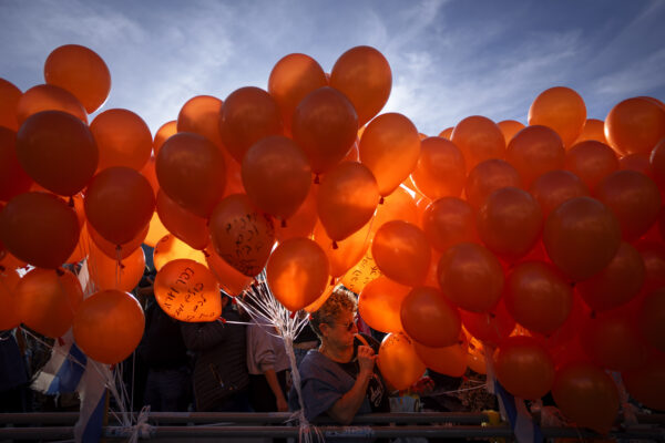 TEL AVIV — The impact of orange color in the sun: Demonstrators hold orange balloons at a rally in solidarity with Kfir Bibas, an Israeli boy who spent his first birthday Thursday in Hamas captivity in the Gaza Strip, in Tel Aviv, Israel, Thursday, Jan. 18, 2024. The plight of Bibas, the youngest hostage held by Hamas, has captured the nation's attention and drawn attention to the government's failure to bring home more than 100 hostages still held by Hamas after more than three months of war.Photo: Oded Balilty/AP