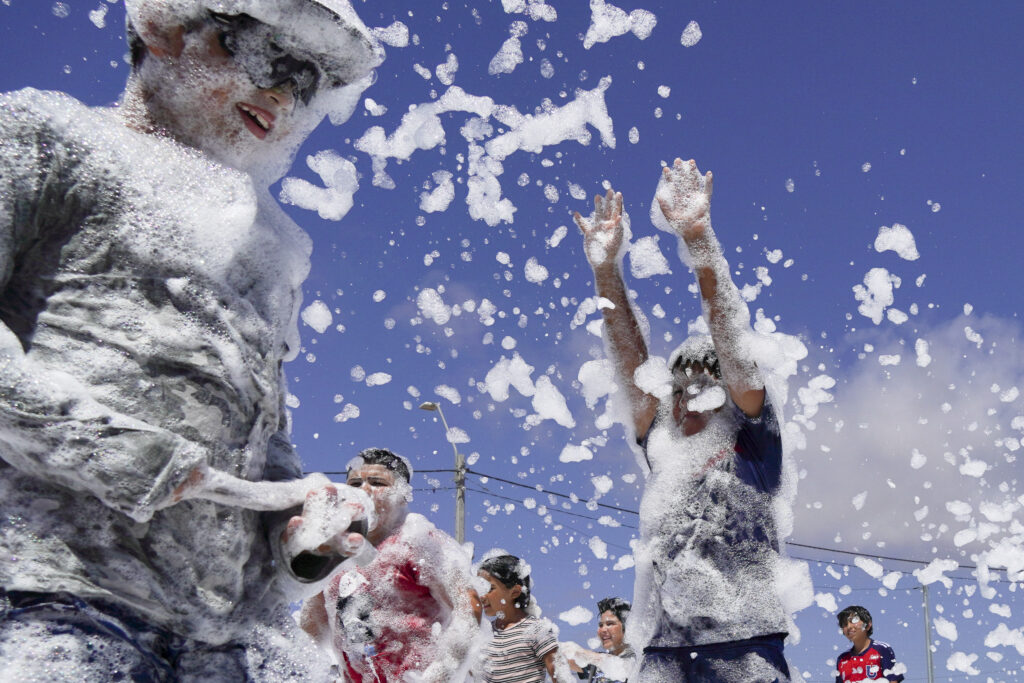 CHILE — A staple of summer fun anywhere — soap bubbles: Children play on a court blanketed with soap foam during a summer activity in Tongoy, Chile, Thursday, Jan. 25, 2024.Photo: Matias Basualdo/AP