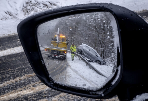 FRANKFURT — Wonder what it’s like on the Autobahn: A view in a car mirror shows a car that veered off a country road near Frankfurt, Germany, Thursday, Jan. 18, 2024, as heavy snow falls in many parts of Germany.Photo: Michael Probst/AP
