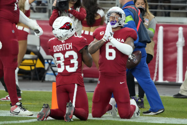 <b>ARIZONA — The power of prayer… or at least the drama of kneeling:</b> Arizona Cardinals running back James Conner (6) celebrates with Greg Dortch (83) after Conner scored a touchdown against the Seattle Seahawks in the second half of an NFL football game Sunday, Jan. 7, 2024, in Glendale, Ariz.<br>Photo: Rick Scuteri/AP