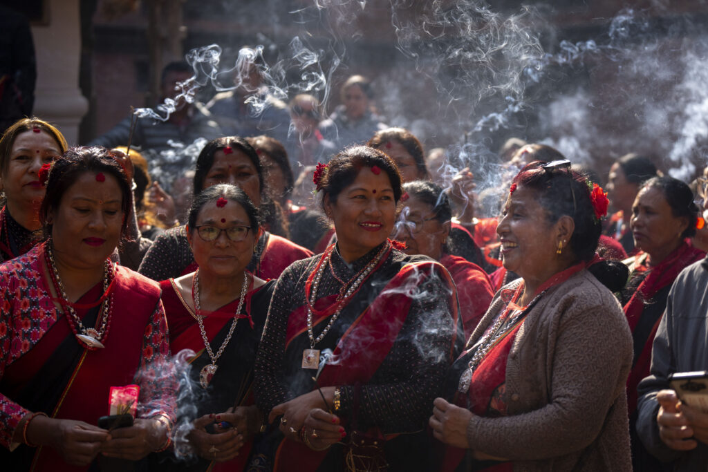 NEPAL — A ceremony for repatriated art: Women in traditional attire light incense sticks as a 16th-century statue of Hindu deity Uma-Maheswora, which was stolen four decades ago and later repatriated is paraded before reinstating the same at the premises of a temple where it belonged in Lalitpur, Nepal, Thursday, Feb. 15, 2024. The idol had somehow ended up at the Brooklyn Museum in New York, which handed over the same to the Manhattan District Attorney's Office, paving the way to its return to Nepal.Photo: Niranjan Shrestha/AP