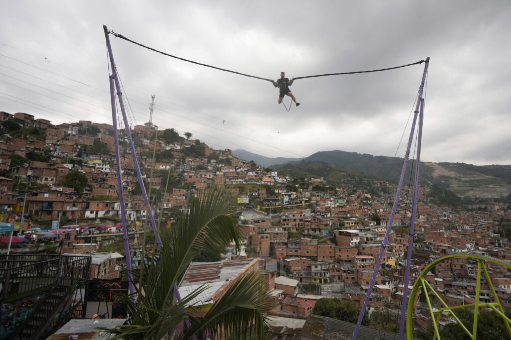 COLOMBIA — ‘Is that Philippe Petit? Nahhh…’: A tourist rides a bungee jump in the Comuna 13 neighborhood of Medellin, Colombia, Friday, Feb. 2, 2024. Once a battleground for fighting among drug cartels, leftist guerrillas, military forces, and government-linked paramilitary groups, the area is now a tourist attraction.Photo: Fernando Vergara/AP