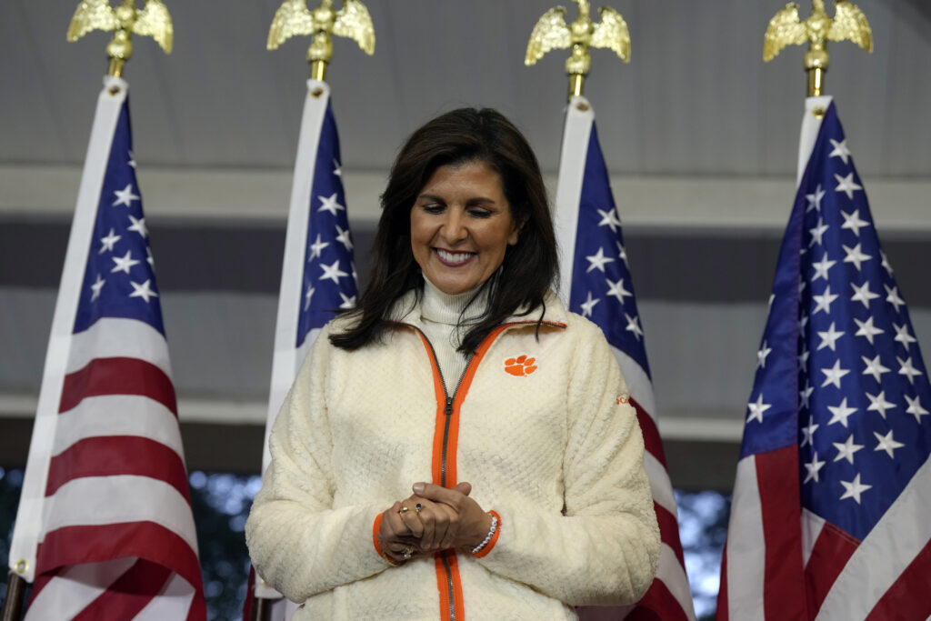 SOUTH CAROLINA — Clasping her hands and praying, “Will they remember me?”: Republican presidential candidate former UN Ambassador Nikki Haley smiles as she's introduced at a campaign rally on Tuesday, Feb. 20, 2024, in Clemson, SC.Photo: Meg Kinnard/AP