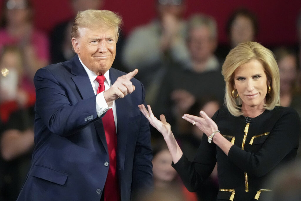 SOUTH CAROLINA — Still wearing a red tie: Republican presidential candidate former President Donald Trump and moderator Laura Ingraham gesture on stage during a Fox News Channel town hall Tuesday, Feb. 20, 2024, in Greenville, S.C.Photo: Chris Carlson/AP