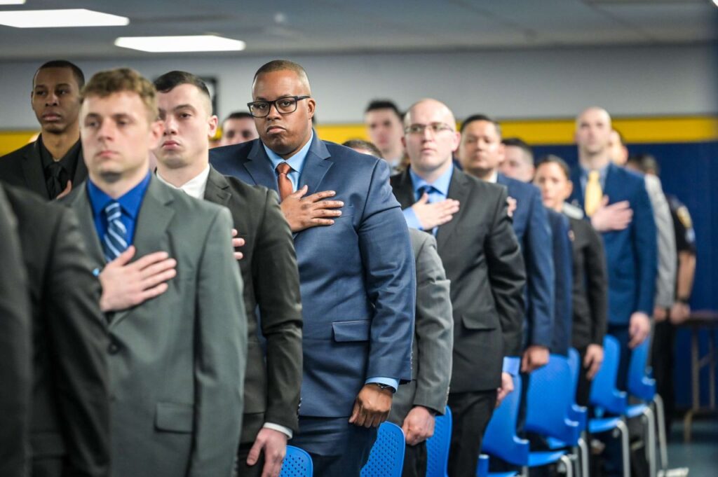 New court officer recruits stand with hands over hearts, pledging allegiance to mark the beginning of their rigorous training journey at the Court Officer Academy.Photos courtesy of the NYS Unified Court System
