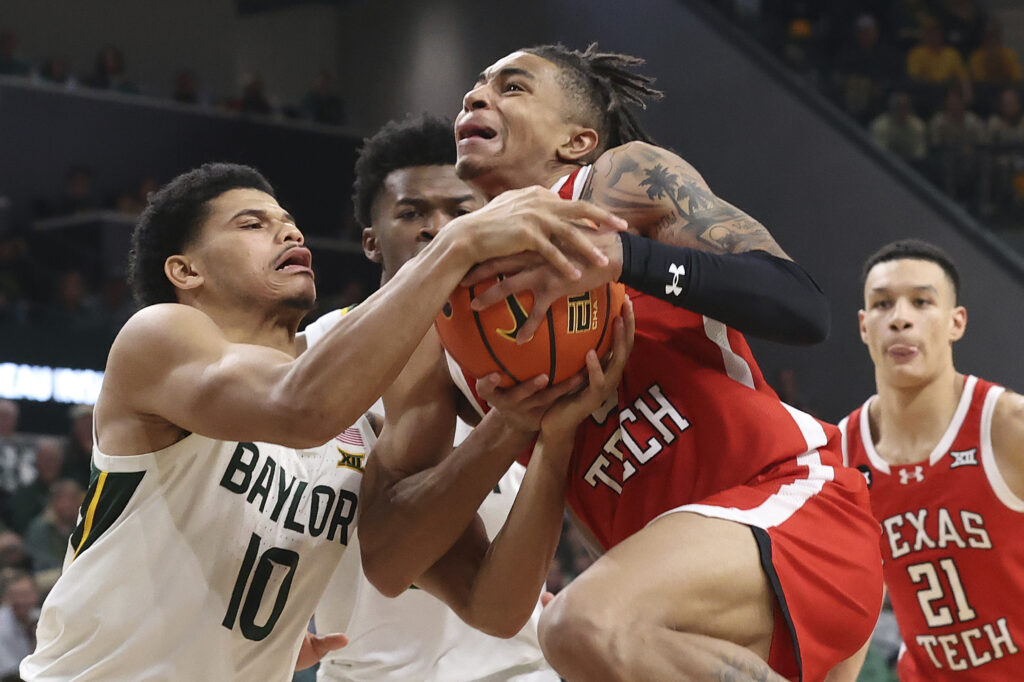 WACO — ‘How can we get more hands on this ball?’ Texas Tech guard Chance McMillian (0), right, and Baylor guard RayJ Dennis (10), left, battle for control of the ball during the second half of an NCAA college basketball game Tuesday, Feb.6, 2024, in Waco, Texas.Photo: Jerry Larson/AP