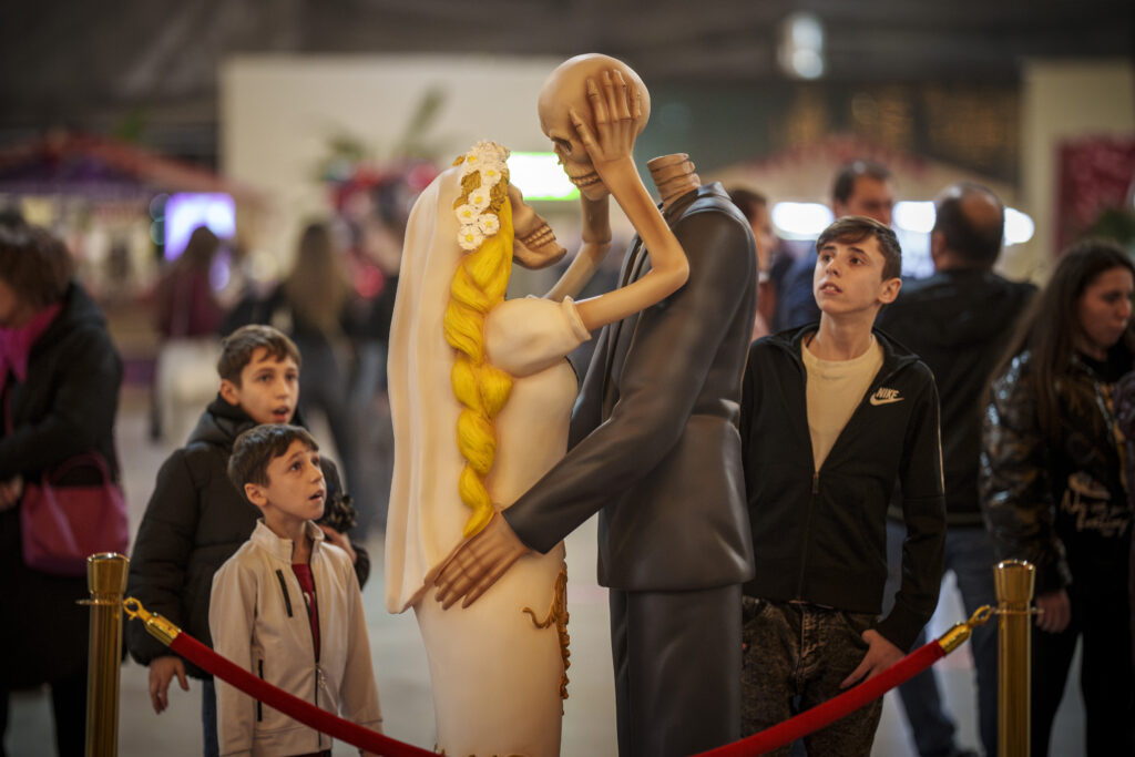 BUCHAREST — Just like the Praying Mantis? People look at a skeleton couple kissing installation dubbed " 'Till Death Do Us Part" during a Valentine's Day event in Bucharest, Romania, Tuesday, Feb. 13, 2024.Photo: Vadim Ghirda/AP