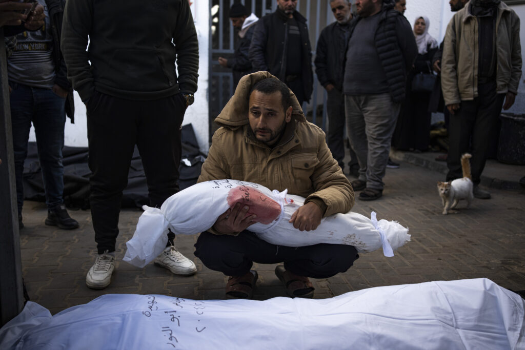 GAZA — A child in the wrong place at the wrong time: A man holds the body of his daughter who was killed in the Israeli bombardment of the Gaza Strip, at a hospital morgue in Rafah, Wednesday, Feb. 21, 2024.Photo: Fatima Shbair/AP