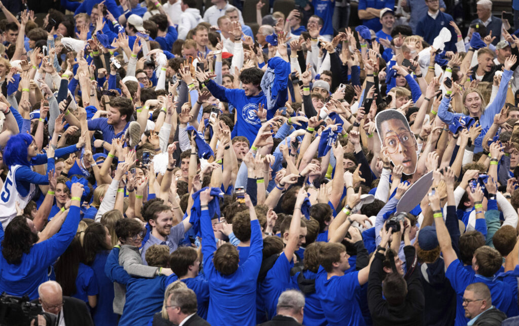 OMAHA — The energetic joy of an upset: Creighton fans storm the court following the team's 85-66 win over UConn in an NCAA college basketball game Tuesday, Feb. 20, 2024, in Omaha, NE.Photo: Rebecca S. Gratz/AP