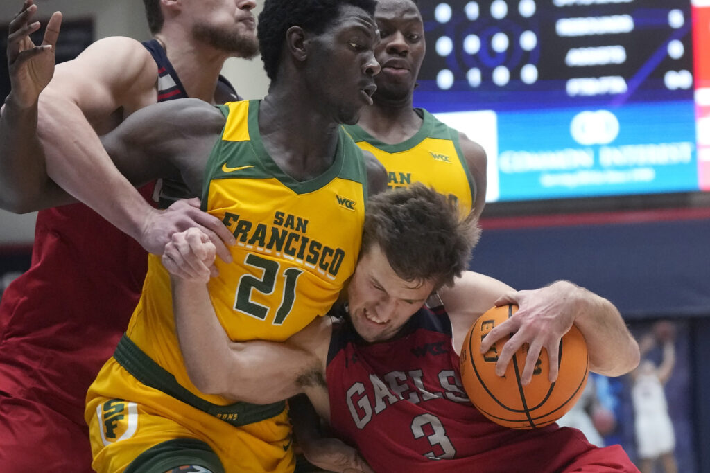 CALIFORNIA — “Sometimes when we touch, the honesty’s too much”: Saint Mary's guard Augustas Marciulionis (3) drives to the basket against San Francisco forward Ndewedo Newbury during the first half of an NCAA college basketball game in Moraga, CA, Tuesday, Feb. 20, 2024.Photo: Jeff Chiu/AP