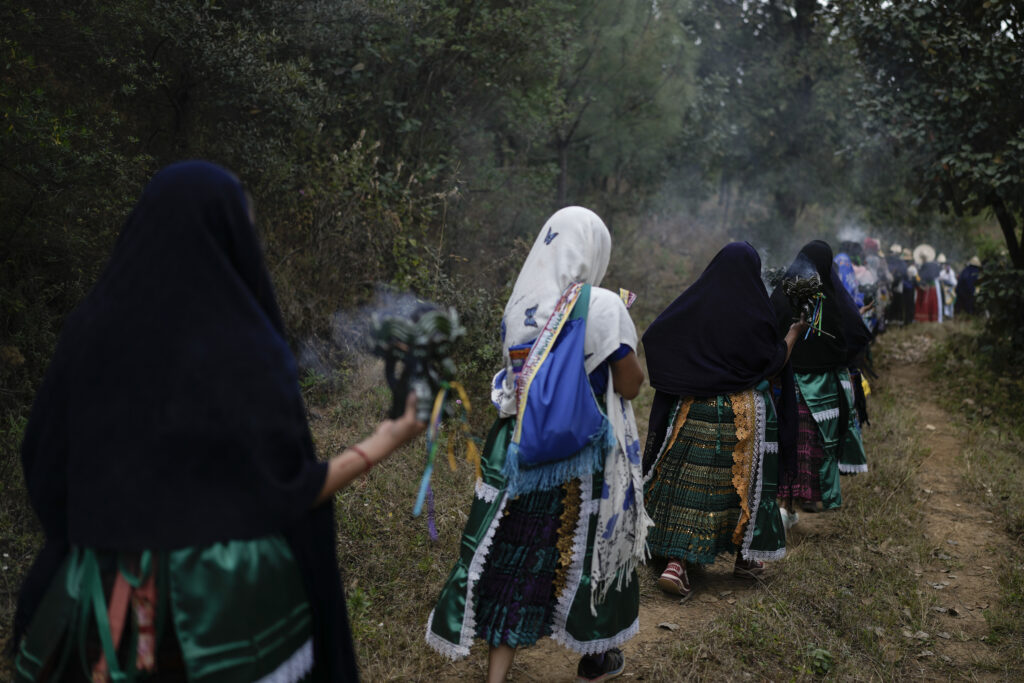 MEXICO — Indigenous ceremonies continue for ‘Orphan Day’: Purepechas Indigenous women carry burning copal incense as they escort a flame from Erongaricuaro, where residents kept the fire alive for one year, to Ocumicho in Michoacan state, Mexico, Wednesday, Jan. 31, 2024. A new flame will be lit in Ocumicho at the “New Fire” ceremony on Feb. 2 to mark the new year after extinguishing the old fire on Feb. 1, which is considered an orphan day that belongs to no month and is used for mourning and renewal.Photo: Eduardo Verdugo/AP