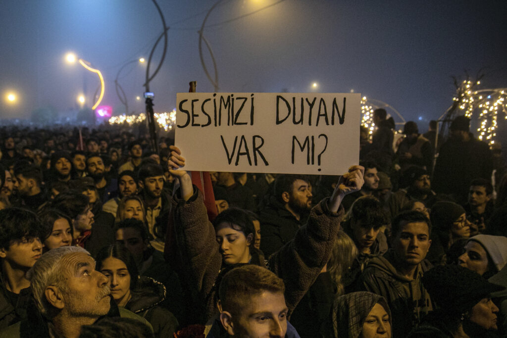 TURKEY — Remembering those lost in the devastating quake: People gather to mark the one-year anniversary of the country's catastrophic earthquake in the city of Antakya, southern Turkey, Tuesday, Feb. 6, 2024. A banner reads, "Anyone can hear my voice?"Photo: Metin Yoksu/AP