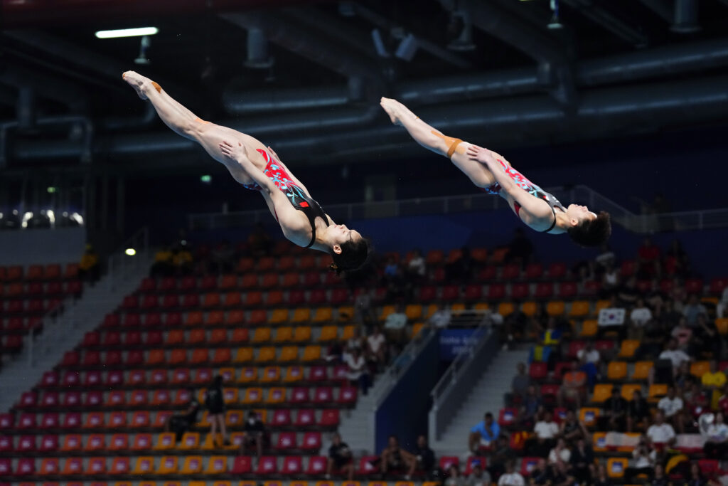 QATAR — Keeping time and form in a parallel dive: Yani Chang and Yiwen Chen of China compete during the women's synchronized 3m springboard diving final at the World Aquatics Championships in Doha, Qatar, Wednesday, Feb. 7, 2024.Photo: Hassan Ammar/AP