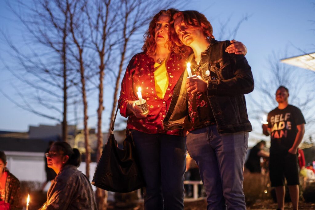OKLAHOMA — The price of being different: Dawn Markle and her son Evan Markle of Adair participate in a community candlelight vigil for Nex Benedict, an Oklahoma teenager who died the day after a fight in a high school bathroom in which the nonbinary student said they were a target of bullying, Sunday, Feb. 25, 2024, in Owasso, OK.Photo: Mike Simons/Tulsa World via AP