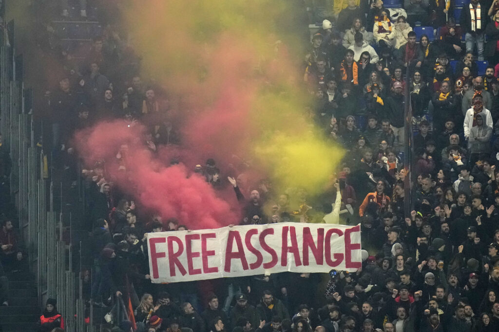 ROME — When huge crowds gather, it’s either a soccer game or a protest — or both: Fans hold flares and a banner that reads "Free Assange" during the Europa League play-off second leg soccer match between Roma and Feyenoord at Rome's Olympic stadium, Thursday, Feb. 22, 2024.Photo: Alessandra Tarantino/AP