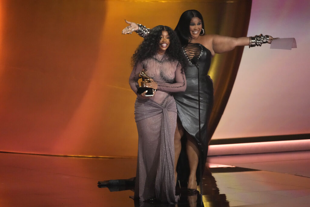 LOS ANGELES — The Grammy’s heard SZA’s “SOS” and awarded her as such: Lizzo, right, presents the award for best R&B song to SZA for “Snooze” during the 66th annual Grammy Awards on Sunday, Feb. 4, 2024, in Los Angeles. SZA’s name (pronounced “sizzah”) was inspired by the Wu-Tang Clan alphabet, a group popular during the 90s.Photo: Chris Pizzello/AP