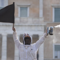 ATHENS — Beekeepers abuzz with a stinging issue: A beekeeper holds a black flag in front of the Greek Parliament during a demonstration in central Athens, Greece, Thursday, Feb. 22, 2024. Beekeepers from around the country rallied in Syntagma Square with demands, including the end of naming imported honey “Greek.”Photo: Michael Varaklas/AP