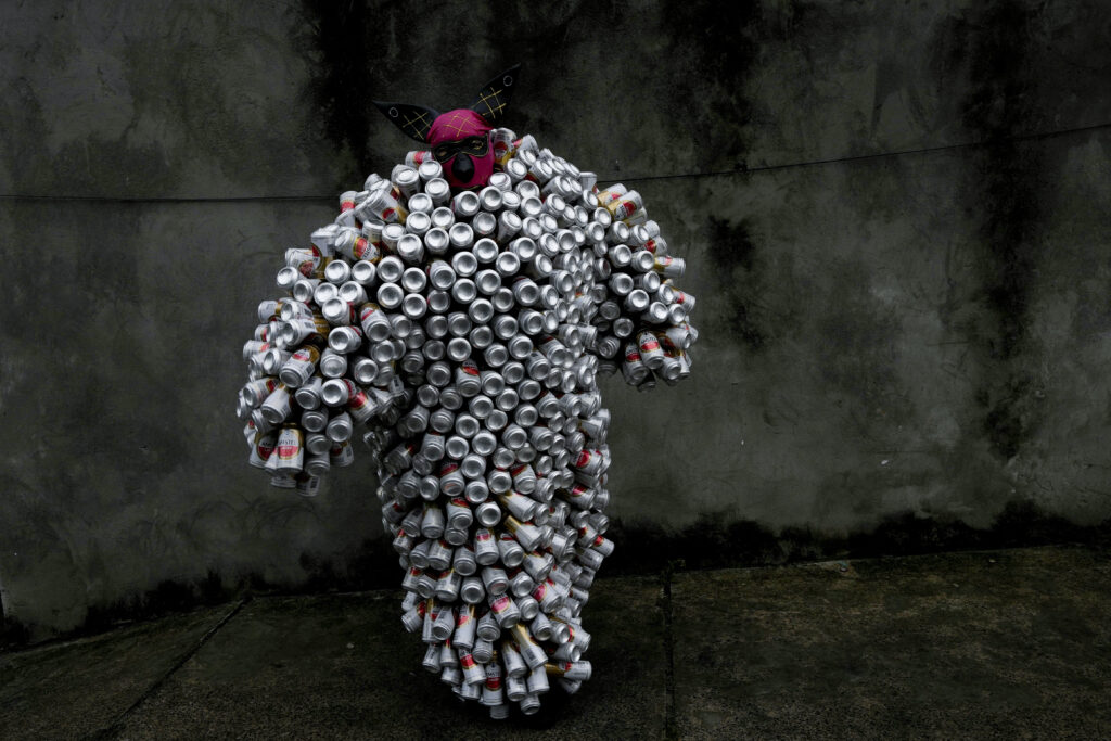 MADRE DE DEUS — Creative recycling: A reveler wearing a costume made from beer and soda cans takes part in the 'Bloco da Latinha' street party Carnival parade in Madre de Deus, Brazil, Sunday, Feb. 11, 2024.Photo: Eraldo Peres/AP