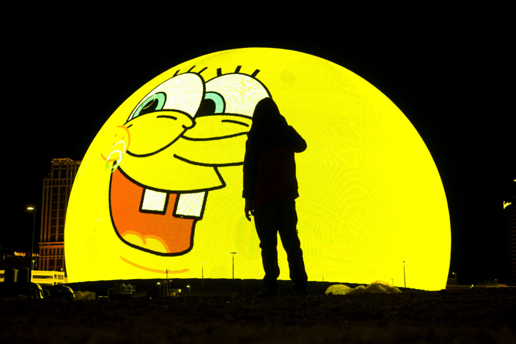 LAS VEGAS — “Taylor, is that you?” is what Spongebob is apparently saying, but she says no: A person is silhouetted against an advertisement playing on Sphere, Thursday, Feb. 8, 2024, in Las Vegas.Photo: Charlie Riedel/AP