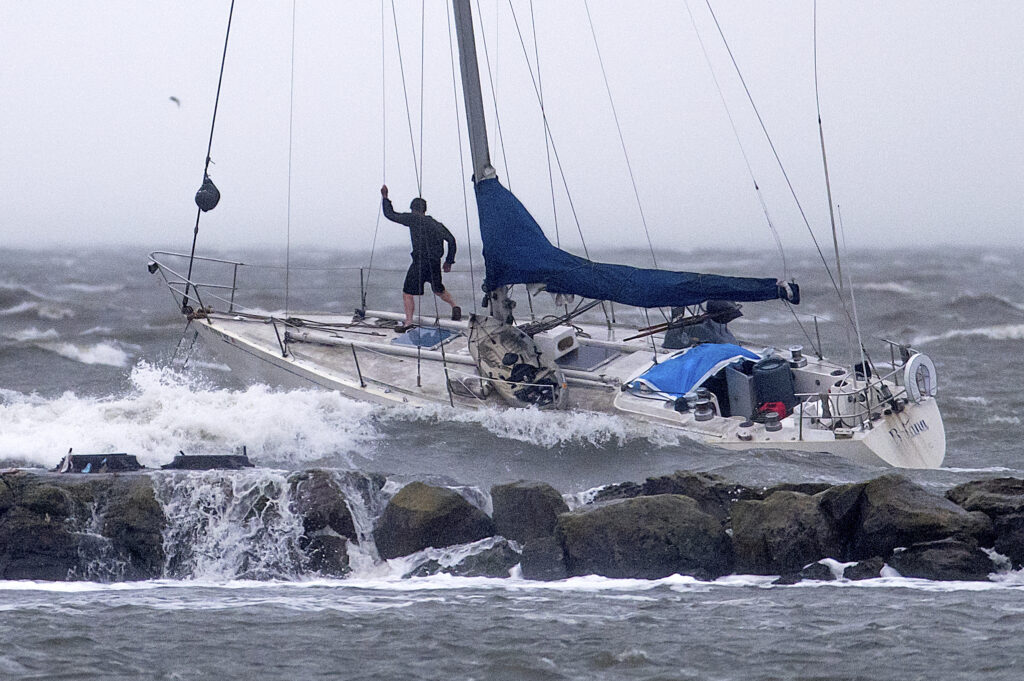 CALIFORNIA — Nearby rocks look too much so: A boater stands on the bow of an anchored sailboat as waves crash over a breakwater in Alameda, CA, Sunday, Feb. 4, 2024, in Alameda, Calif. High winds and heavy rainfall are impacting the region.Photo: Noah Berger/AP