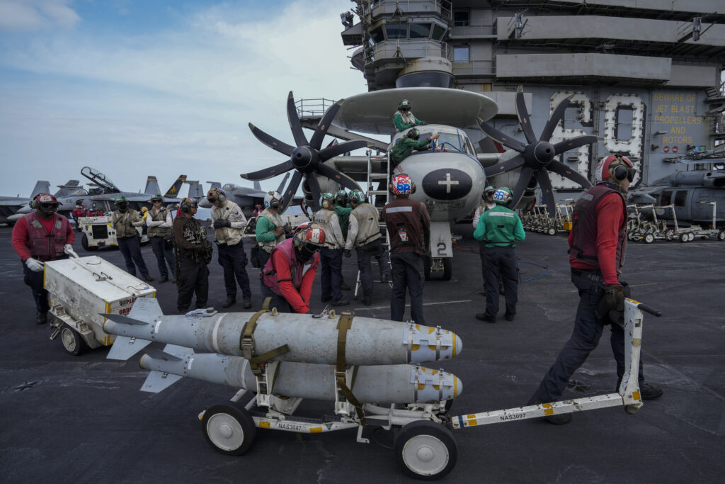 RED SEA — Bombs foreboding continued involvement in Yemen: Crew members work on the deck of the aircraft carrier U.S.S. Dwight D. Eisenhower, also known as the 'Ike' on the south Red Sea, Monday, Feb. 12, 2024.Photo: Bernat Armangue/AP