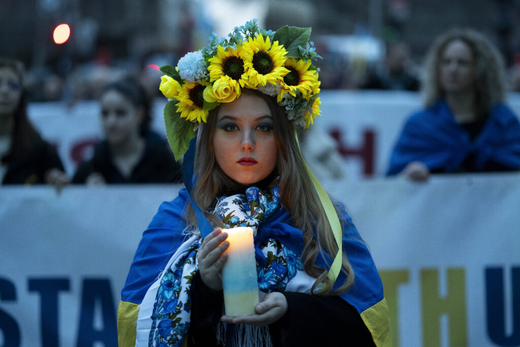BUDAPEST — Flowers of hope and a candle…: A Ukrainian woman holds a candle during a demonstration marking the second anniversary of Russia's invasion of Ukraine in Budapest, Hungary, Saturday, Feb. 24, 2024.Photo: Denes Erdos/AP