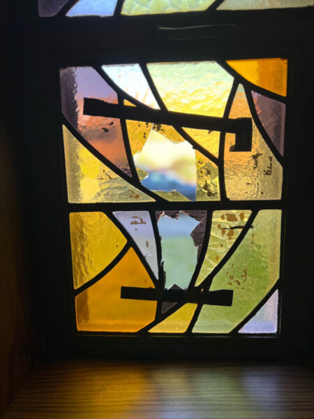 A closeup of the broken stained glass window at St. Columba Church.