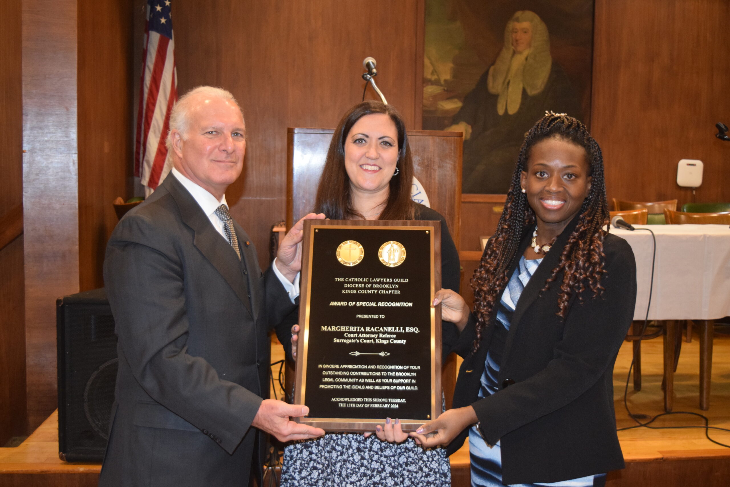 The Catholic Lawyers Guild honored Margherita Racanelli, a court attorney referee in Surrogate’s Court as part of its Shrove Tuesday celebration. Racanelli (center) was presented with a plaque by Gregory Cerchione and Hon. Betsey Jean-Jacques, president of the Guild.Photos: Robert Abruzzese/Brooklyn Eagle