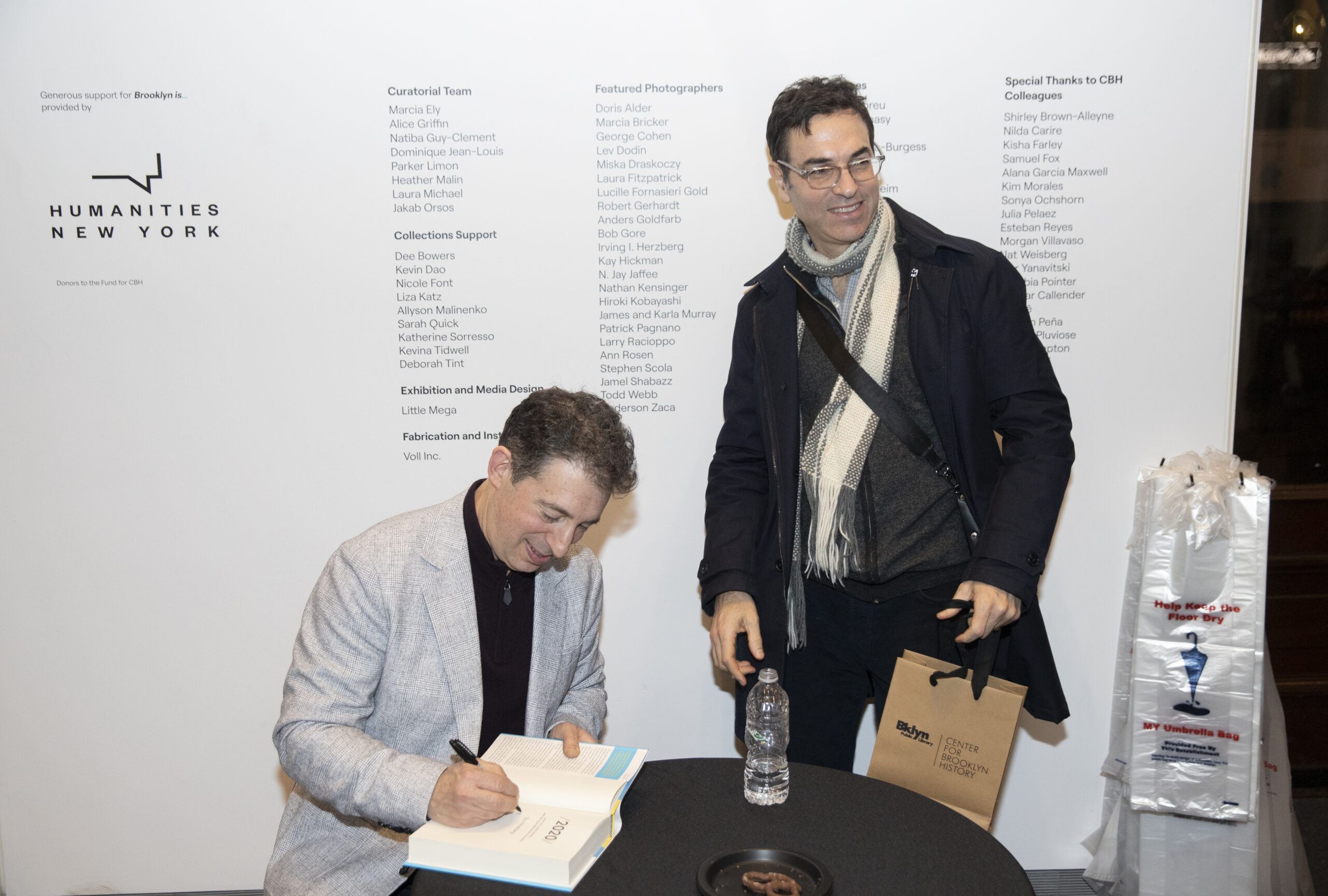 Eric Kilnenberg signs Eyal Press’s copy of 2020 at Klinenberg's book launch.