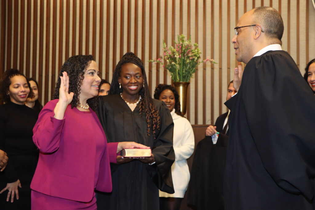 Hon. Joanne Quiñones (in purple) stands next to Hon. Betsey Jean-Jacques as she is sworn in as the latest Kings County Supreme Court Justice by Hon. Hector LaSalle, Presiding Justice of the Appellate Division, Second Department.Photos: Mario Belluomo/Brooklyn Eagle