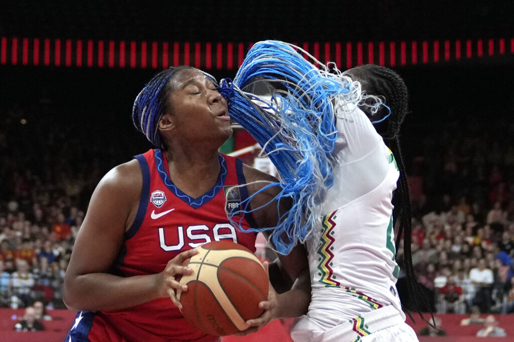 BELGIUM — She takes ‘red, white, and blue’ to heart: Senegal's Mathilde Diop, right, guards against United States Jewell Loyd during a Women's Olympic Qualifying group A basketball match between the United States and Senegal in Antwerp, Belgium, Sunday, Feb. 11, 2024.Photo: Virginia Mayo/AP